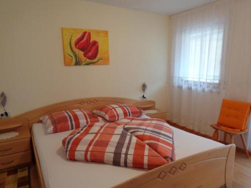 a bedroom with a bed with two pillows on it at Waldoase in Schenna