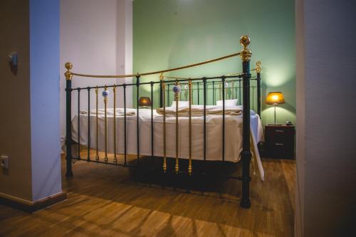 a bedroom with a bed with a metal frame at Hotel Alexander in Wiesbaden