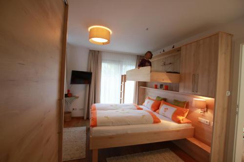 a bedroom with a bed and a person on the top bunk at Appartement Wildkogel in Neukirchen am Großvenediger
