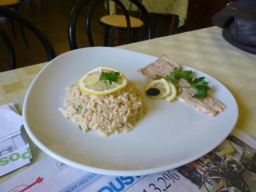 a plate of food with rice and a lemon on it at Albergo Vecchio Forno in Spoleto