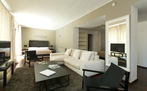 a living room with a couch and a bed at Hotel Zhero in Cas Catala