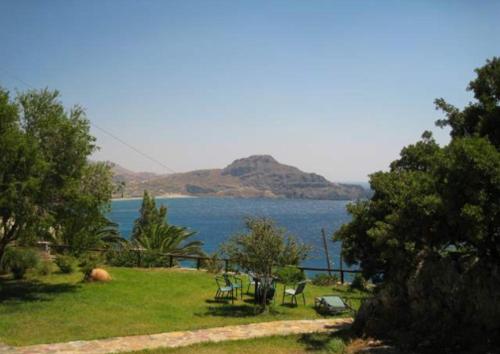 a view of a body of water with a mountain at Elgini Studios in Plakias