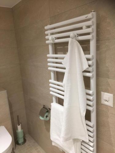 a towel rack in a bathroom with white towels at La Béraille in Thônex