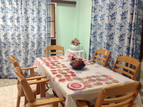 a dining room with a table and chairs with a table and a table at Daddy's homestay in Ban Bang Krasan