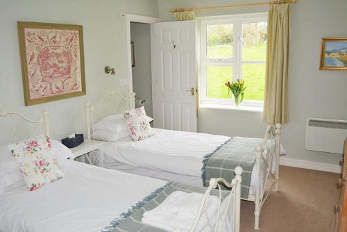 Voodi või voodid majutusasutuse Stable Cottage toas