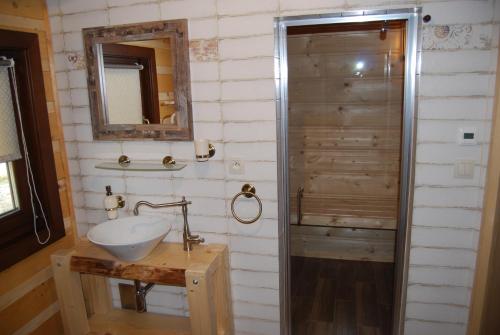 a bathroom with a sink and a shower at Chata Nezábudka in Oščadnica
