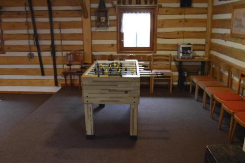 a chess table in a room with chairs and a window at Chalupa Dana in Víchová nad Jizerou