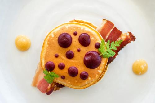 a plate with a cake shaped like a mickey mouse pancake at Sala Resort Plateliai & SPA in Plateliai
