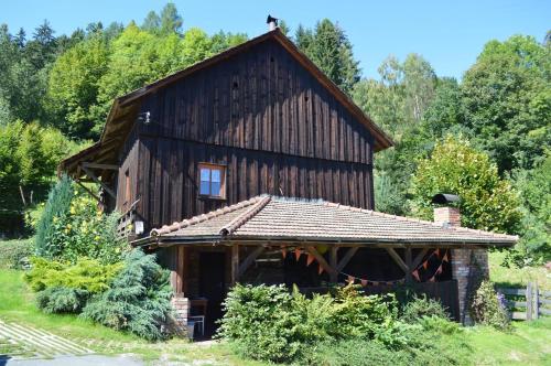 a large wooden barn with a roof at Chalupa Dana in Víchová nad Jizerou
