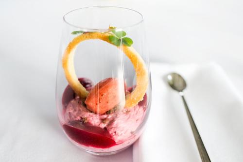 a glass jar filled with red wine and fruit at Sala Resort Plateliai & SPA in Plateliai