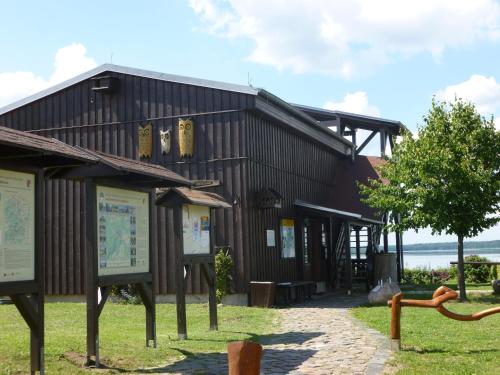 a building with signs in front of it at Landpension Zum Schweizerberg in Neugrimnitz