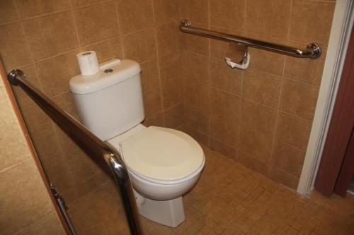 a bathroom with a toilet with a roll of toilet paper at 101 Hotel Bangi in Bangi