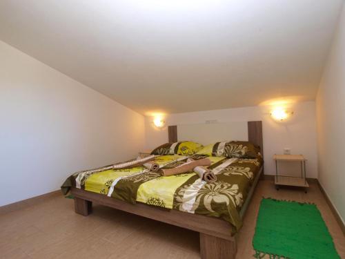 a bedroom with two women laying on a bed at Apartments Biljana 1480 in Ližnjan