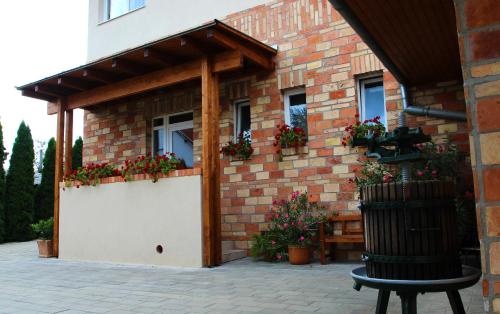 un bâtiment avec un garage blanc fleuri dans l'établissement Vojtek Pince Vendégház, à Villány