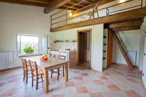 a kitchen with a table and chairs in a room at Cascina Giacometta in Novi Ligure