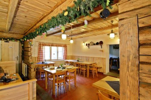 cocina y comedor con mesas y sillas de madera en Penzion pod Pralesem en Velké Karlovice
