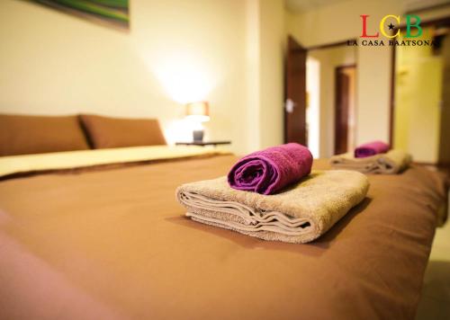 a hotel room with two towels on a bed at La Casa Baatsona Apts in Accra