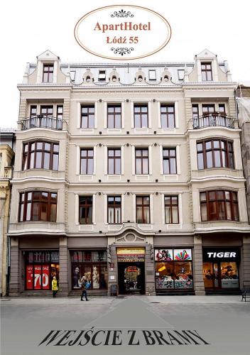 a large white building with people walking in front of it at Aparthotel Łódź 55 Piotrkowska in Łódź
