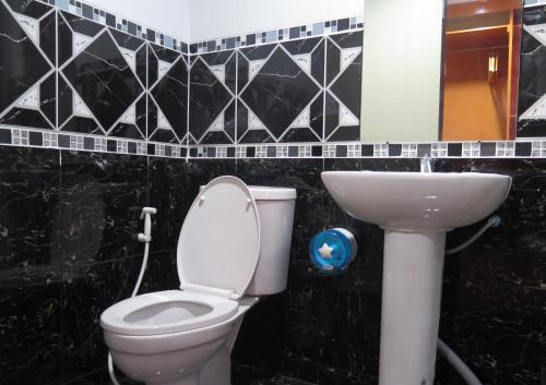 a bathroom with a toilet and a sink at Your Place Inn Surin in Surin
