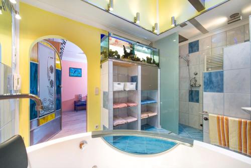 a bathroom with a tub and a shower with a sink at Appart-Pension Seehang in Velden am Wörthersee