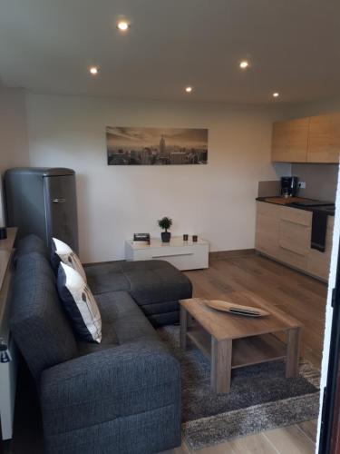 a living room with a couch and a coffee table at Ferienwohnung Leonora in Remagen