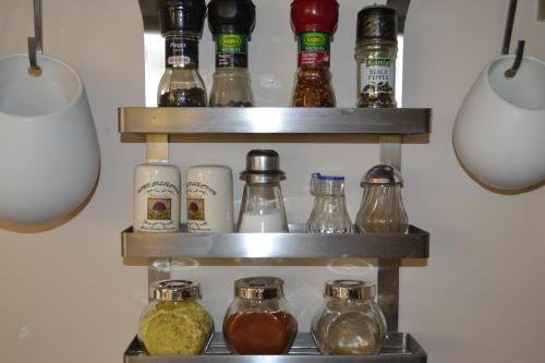 a shelf filled with different types of glass jars at Villa Sole in Pruszcz Gdański