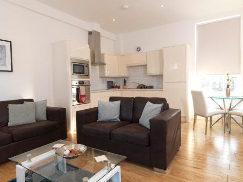 a living room with a couch and a table at Andover Apartments in Andover