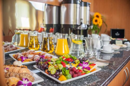 a buffet with two plates of food on a counter at Express Kraków Hotel in Kraków