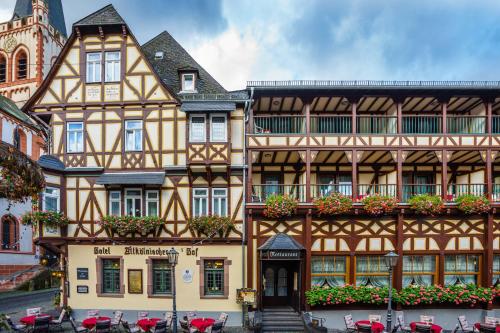 an old building with flowers in front of it at Altkölnischer Hof in Bacharach