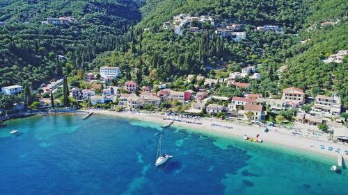 an aerial view of a beach with a boat in the water at Zouli Sophia in Kalami