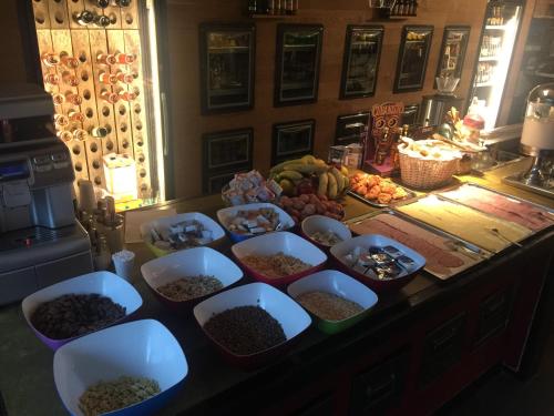a counter with a bunch of bowls of food on it at Auberge des 3 Fontaines in Brussels
