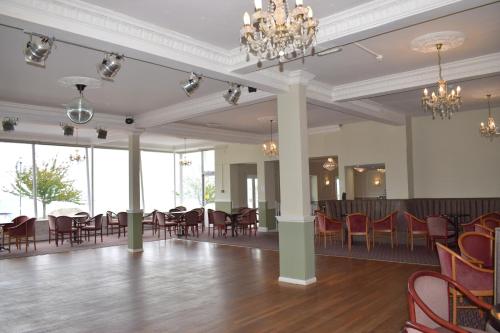 a large room with a table and chairs at The Babbacombe Hotel in Torquay