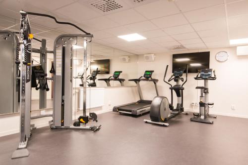 a gym with several treadmills and exercise bikes at Best Western Plus Park Airport Hotel in Arlanda