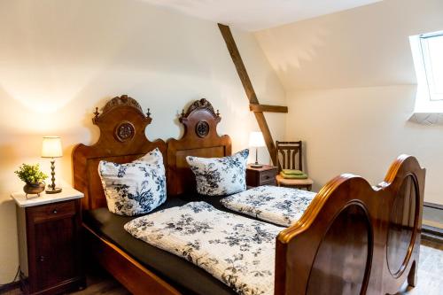 a bedroom with two beds with blue and white pillows at Sophienhof Achternholt in Wardenburg