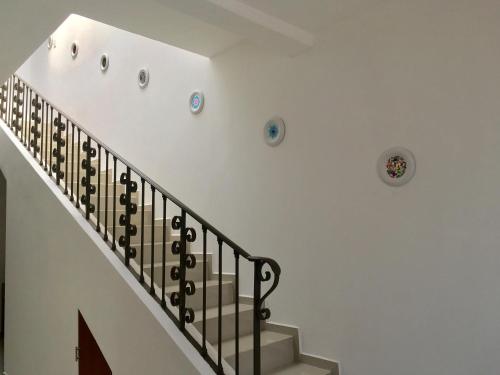 a staircase in a home with white walls and a stair case at Casa Mariel in San Luis Potosí
