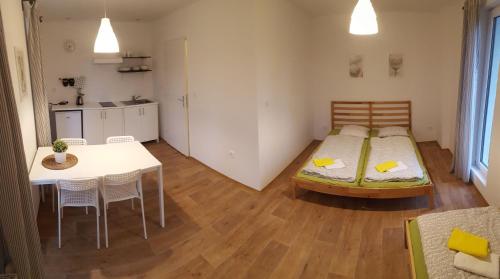 a bedroom with a bed and a table and chairs at Jcamp in Nové Město pod Smrkem