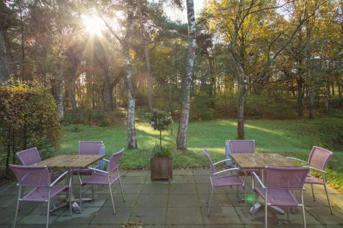 a group of tables and chairs on a patio at Landgoed ISVW in Leusden