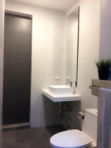 a bathroom with a white sink and a toilet at Baan Saint-Tropez Seaview Villas Kata Beach in Kata Beach