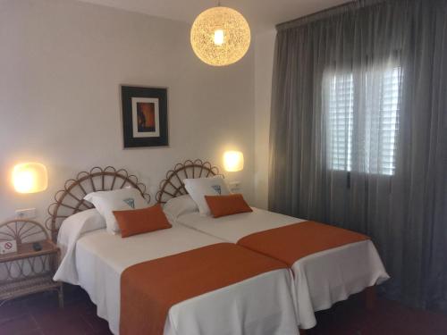 a bedroom with two beds and a window at Chalet Torralba - Villa at Hotel Osiris in San Antonio
