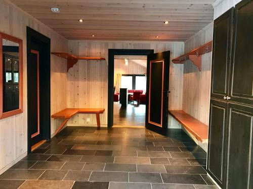 a hallway with wooden walls and benches in a room at Kirkebøen Hytter in Hemsedal