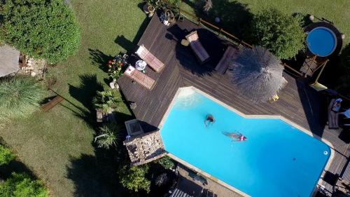 an overhead view of a swimming pool with a person in it at Rancho Paradise - Adults Only in Nono