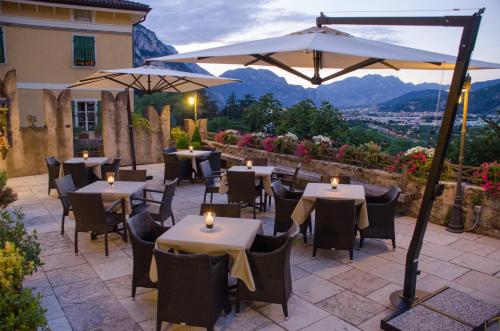 a restaurant with tables and chairs and an umbrella at Hotel Garnì San Giorgio in Trento