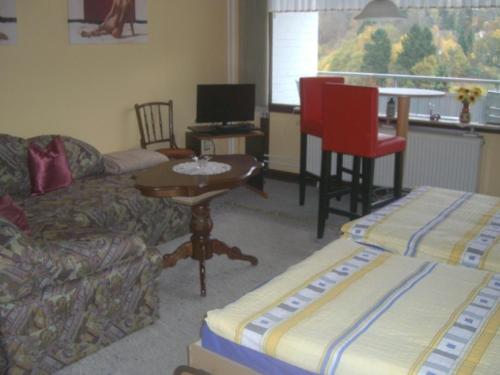 a living room with a couch and a table at Ferien Penthouse Panoramablick oder Studio Panoramablick in Bad Grund