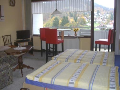 a bedroom with two beds and a table and chairs at Ferien Penthouse Panoramablick oder Studio Panoramablick in Bad Grund