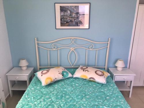 a bedroom with a bed with two pillows on it at Papanikola House 2 in Astypalaia