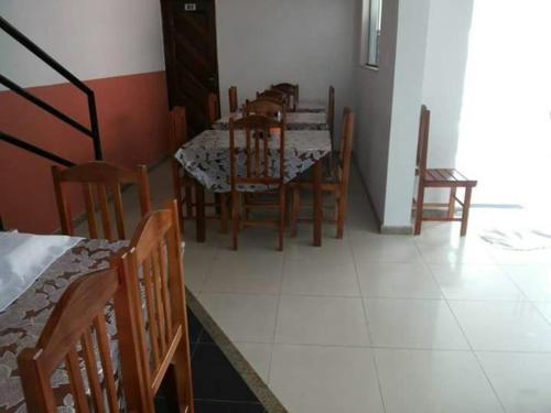 a dining room with a table and chairs at Hotel Reobot in Garanhuns