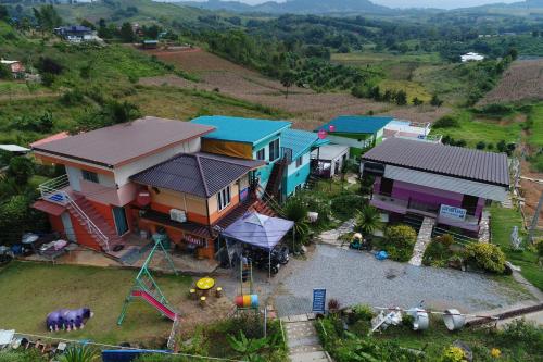 an aerial view of a house with a playground at พักดีโฮม วิวหมอก เขาค้อ in Khao Kho