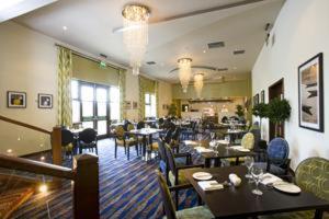 a restaurant with tables and chairs and a dining room at Buchan Braes Hotel in Peterhead