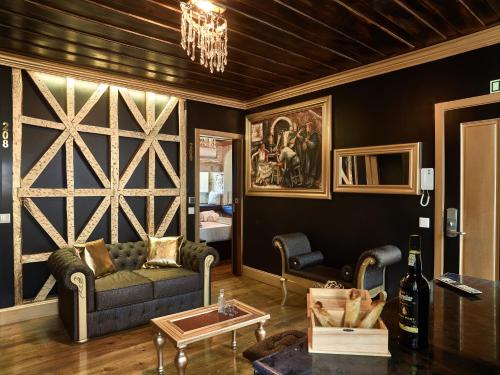 a living room with a couch and a wooden wall at Solar Antigo Luxury Coimbra in Coimbra