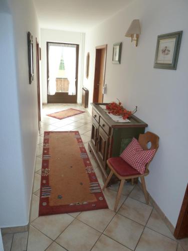 a room with a table and a chair and a rug at Appartement Hauser in Stumm